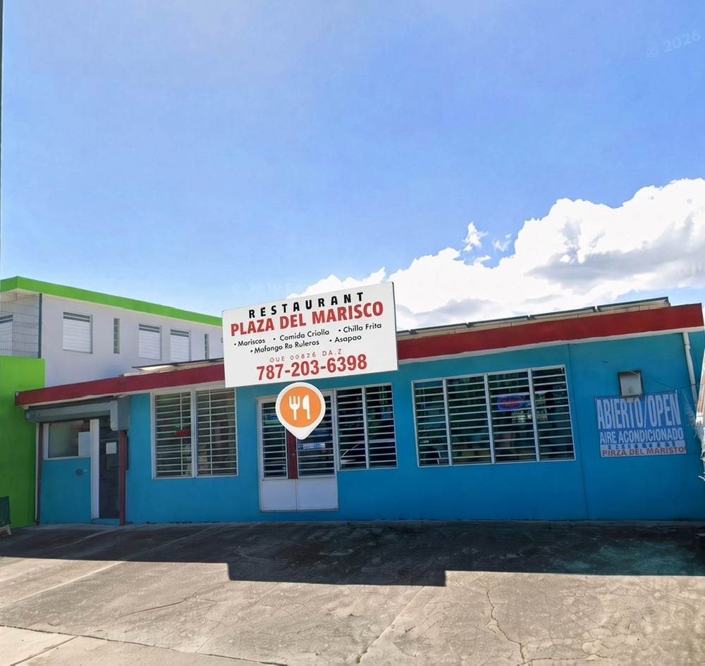 Plaza Del Marisco storefront, teal building with the restaurant sign